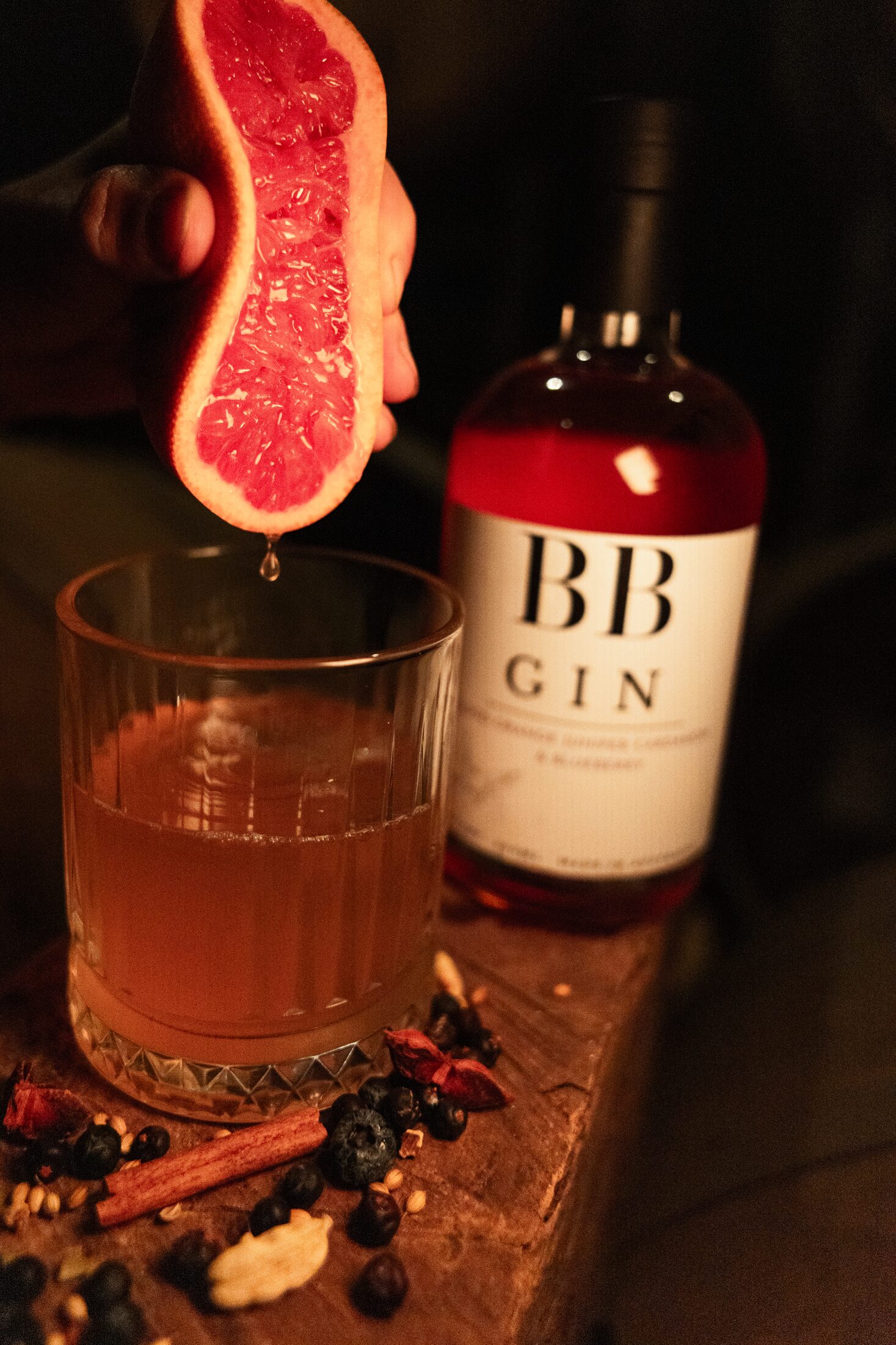 A blood orange negroni beside a bottle of BB Gin
