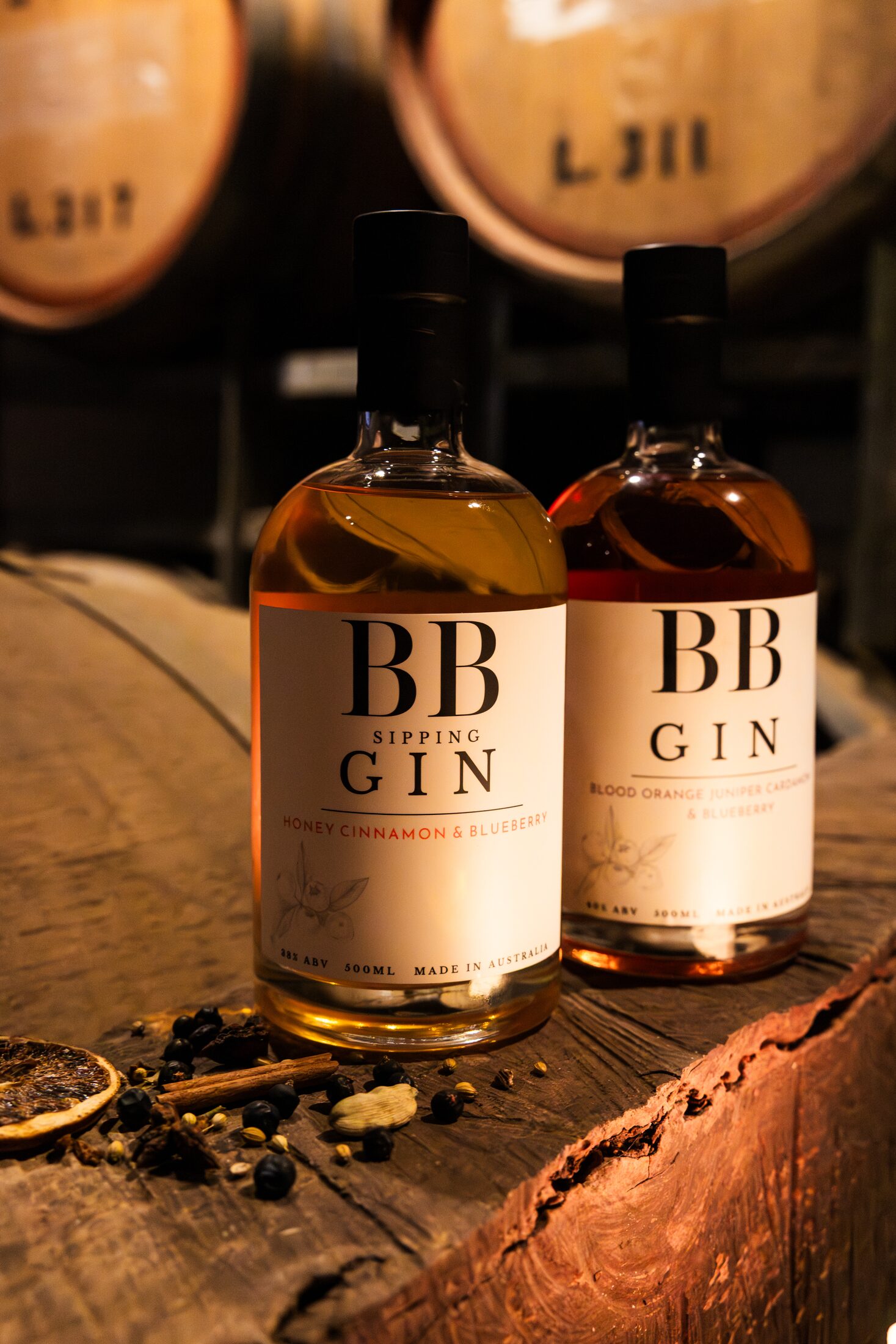 bbgin-range-both-bottles BB Sipping Gin and BB Blood Orange Gin bottles on a barrel head in the barrel room