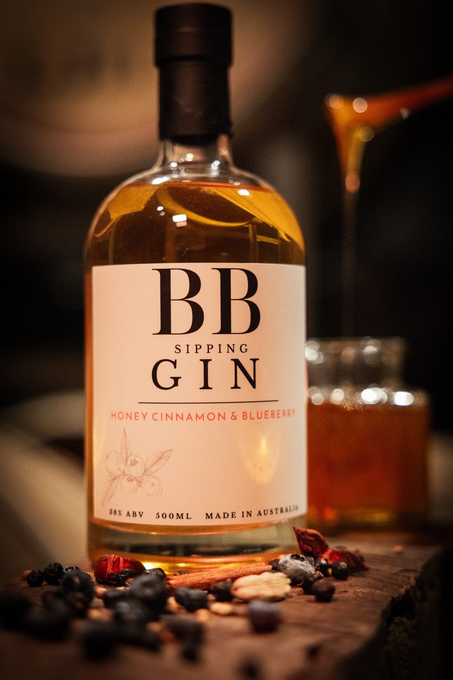 BB Sipping Gin bottle with honey drizzling behind